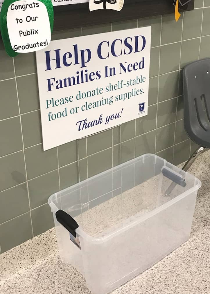 An empty container with a sign above it that reads Help CCSD Families in Need
